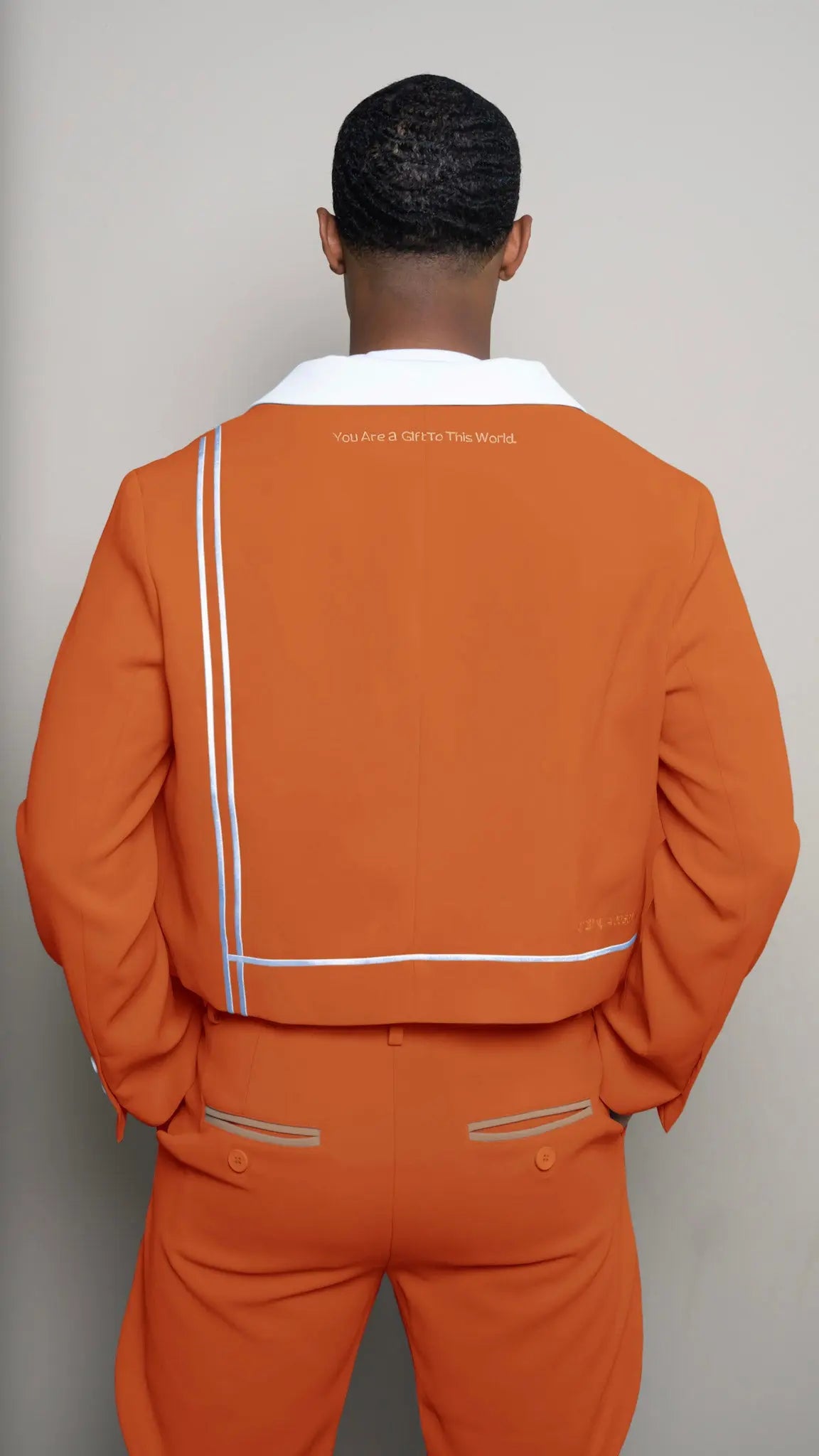 Photo of model in the Arius Juan Nature's Gift: Burnt Orange Cropped Blazer posing for product picture.