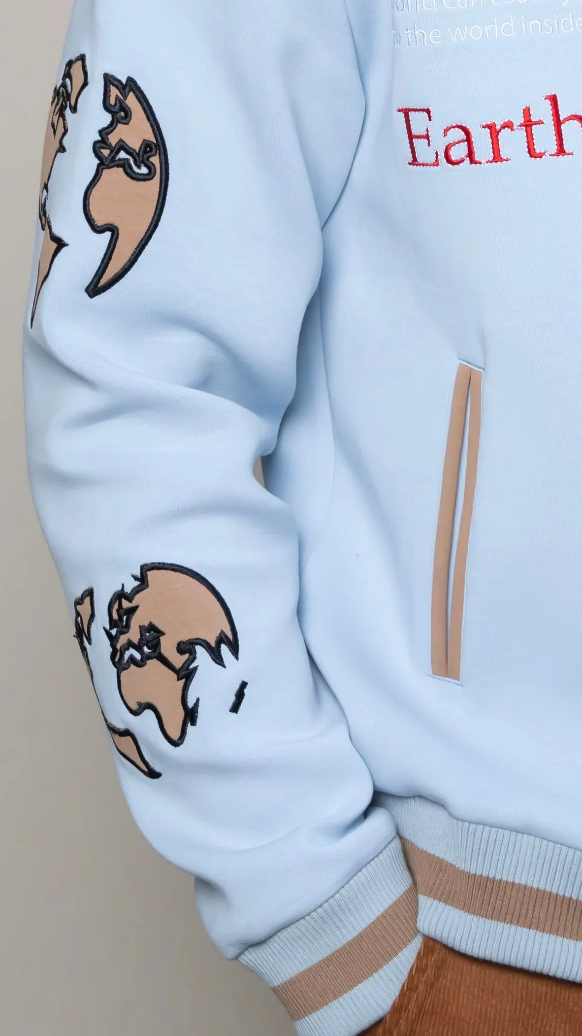 Photo of model in the Arius Juan Sky Blue Worldly Letterman Jacket posing for product picture.