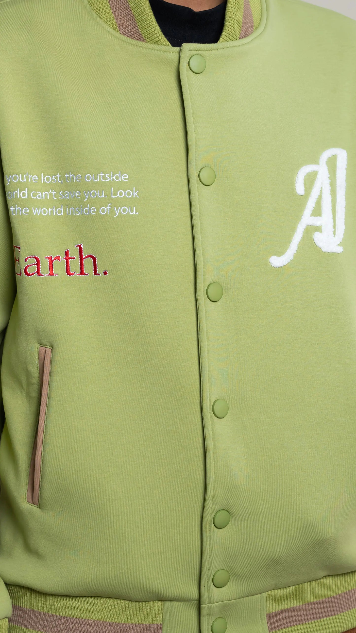 Photo of model in the Arius Juan Olive Green Worldly Letterman Jacket posing for product picture.