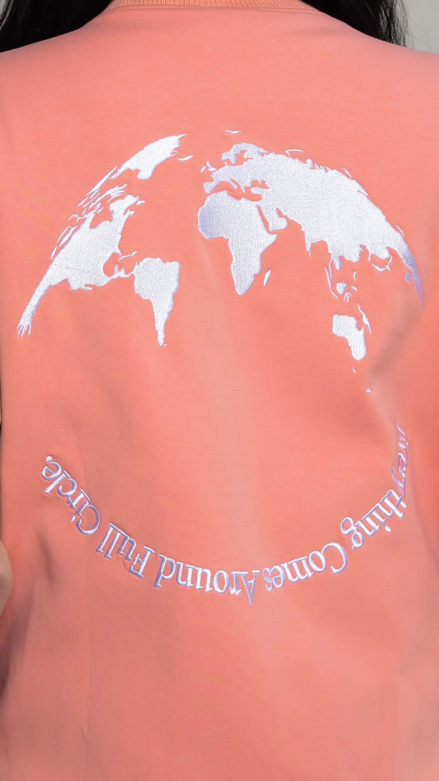 Photo of model in the Arius Juan Salmon Pink Worldly Letterman Jacket posing for product picture.
