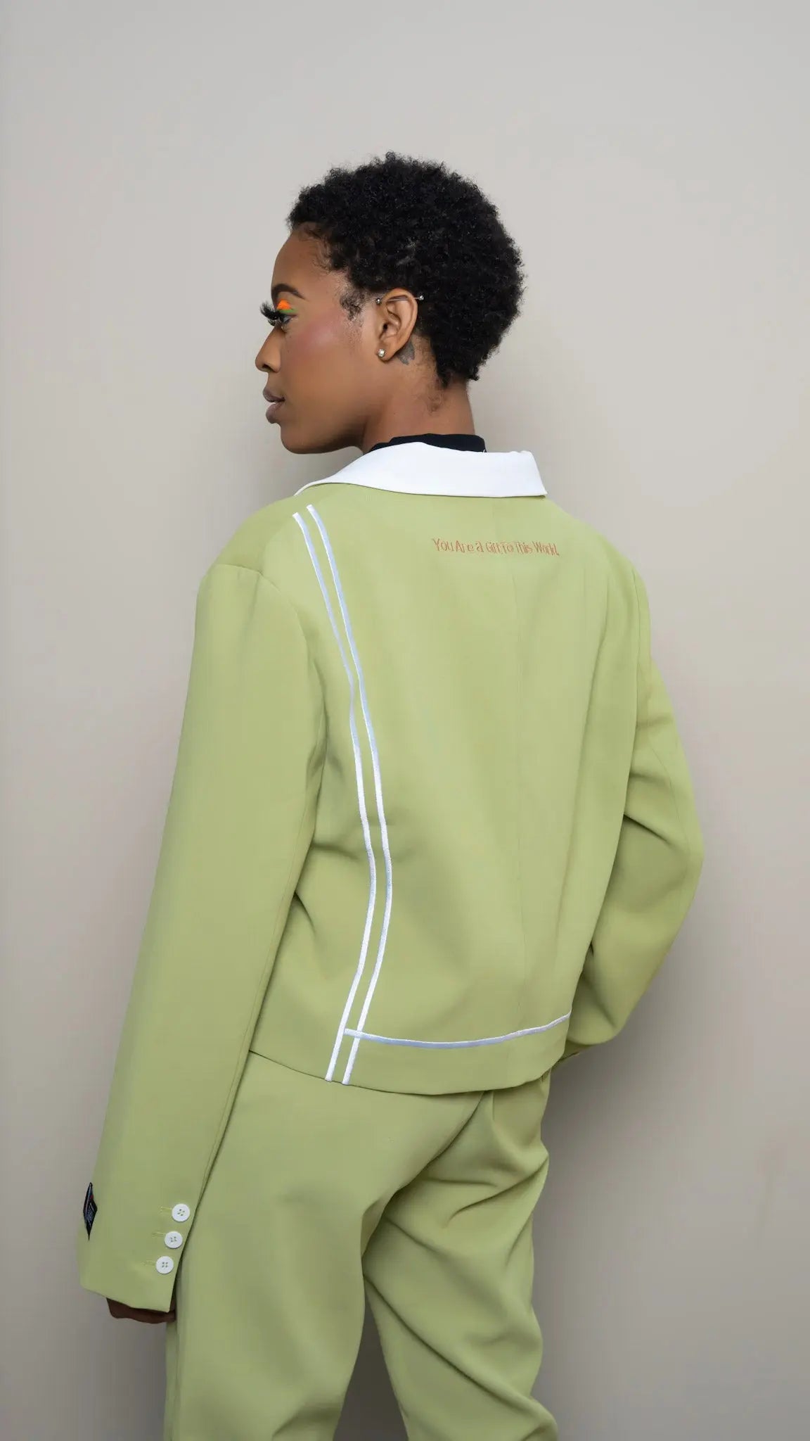 Photo of model in the Arius Juan Nature's Gift: Olive Green Cropped Blazer posing for product picture.