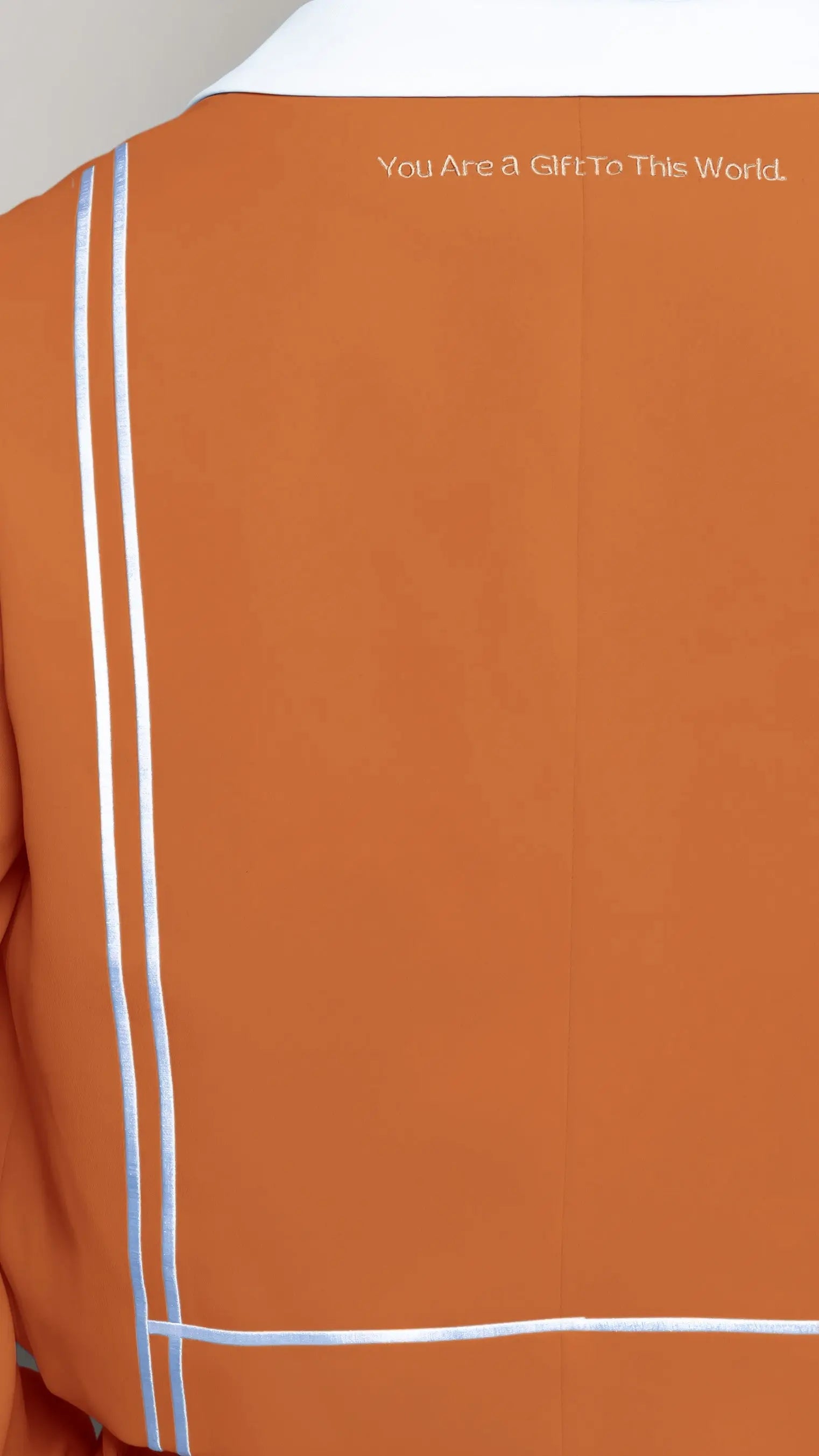 Photo of model in the Arius Juan Nature's Gift: Burnt Orange Cropped Blazer posing for product picture.
