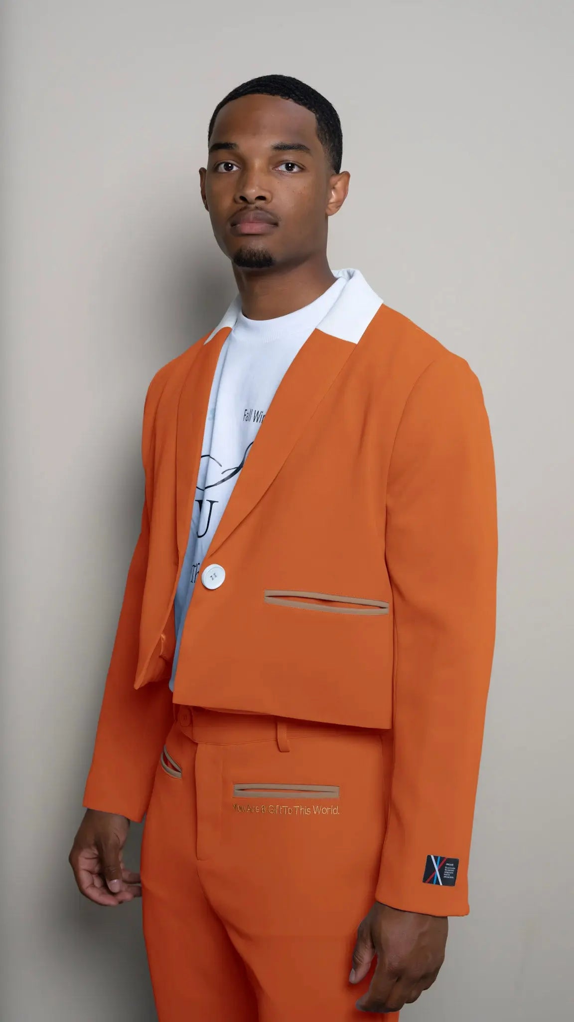 Photo of model in the Arius Juan Nature's Gift: Burnt Orange Cropped Blazer posing for product picture.