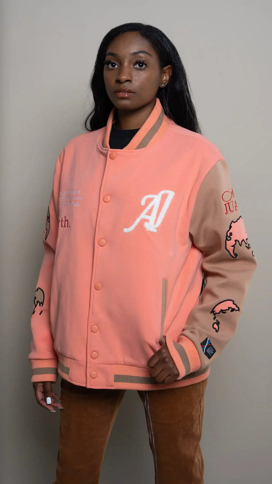 Photo of model in the Arius Juan Salmon Pink Worldly Letterman Jacket posing for product picture.