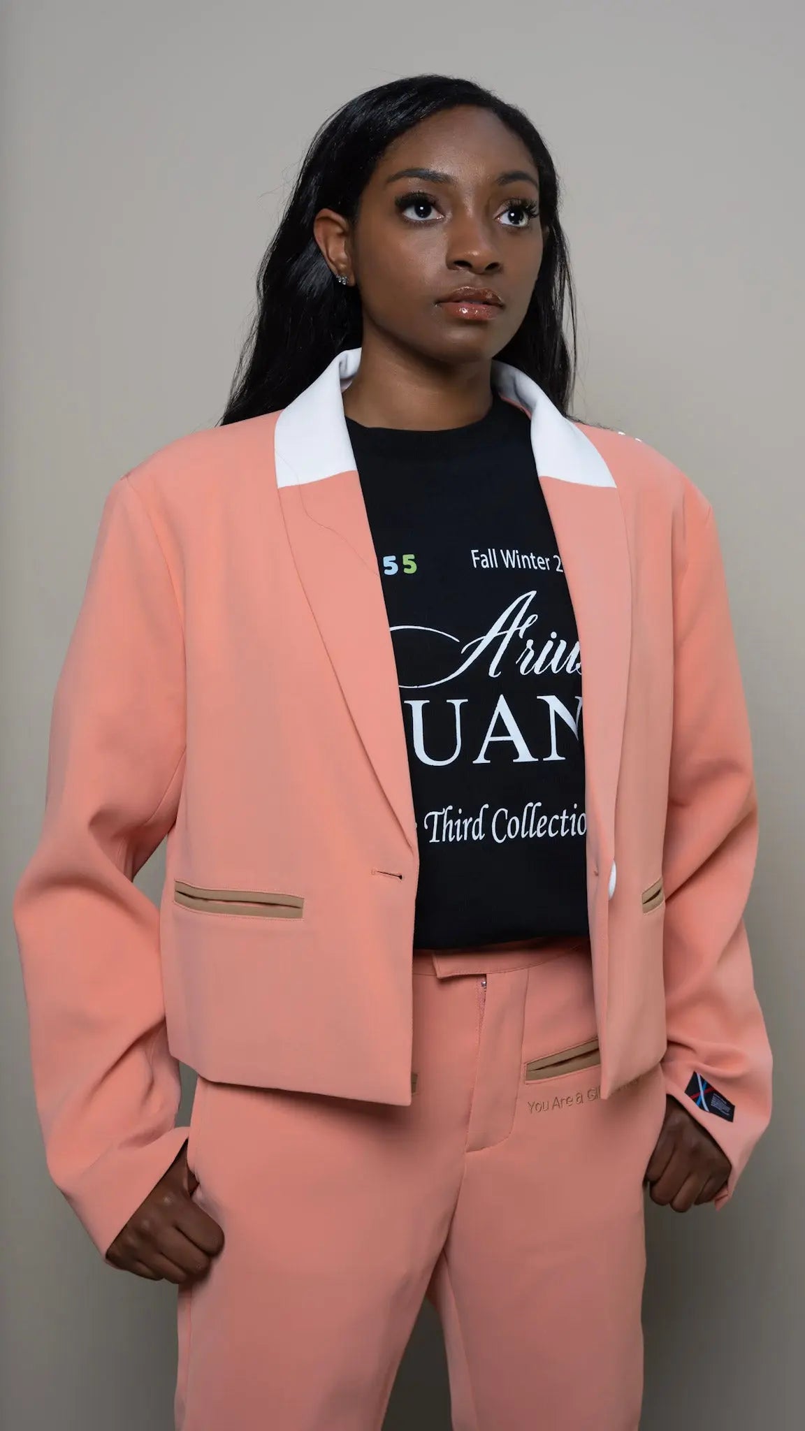 Photo of model in the Arius Juan Nature's Gift: Salmon Pink Cropped Blazer posing for product picture.