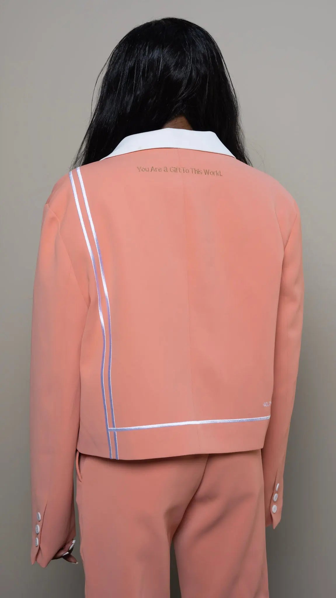 Photo of model in the Arius Juan Nature's Gift: Salmon Pink Cropped Blazer posing for product picture.