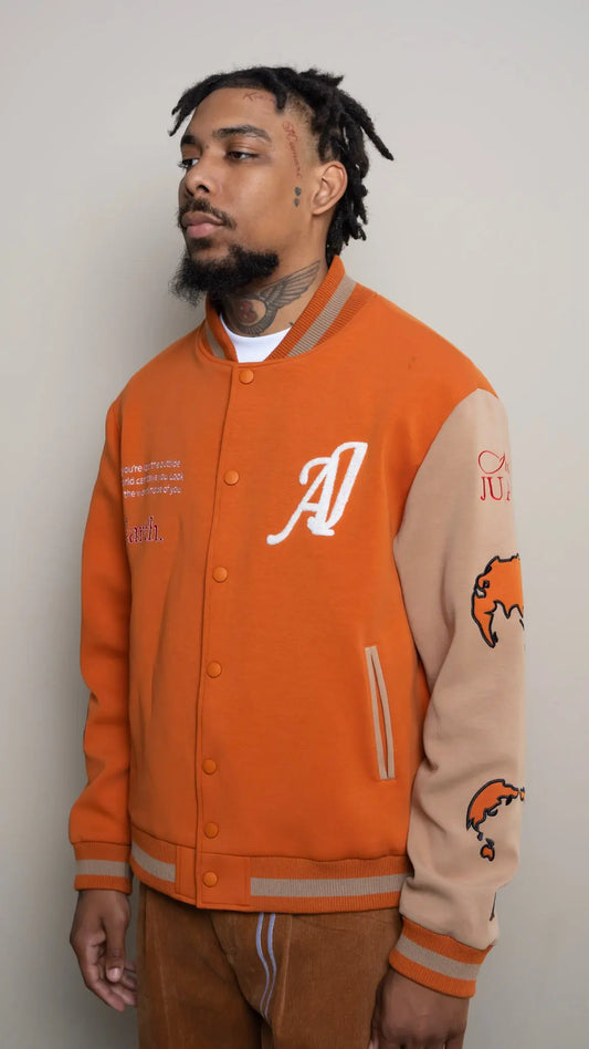 Photo of model in the Arius Juan Burnt Orange Worldly Letterman Jacket posing for product picture.