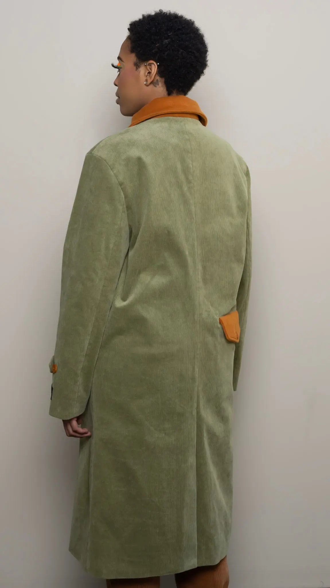 Photo of model in the Arius Juan Olive Green Earthly Trench Coat posing for product picture.