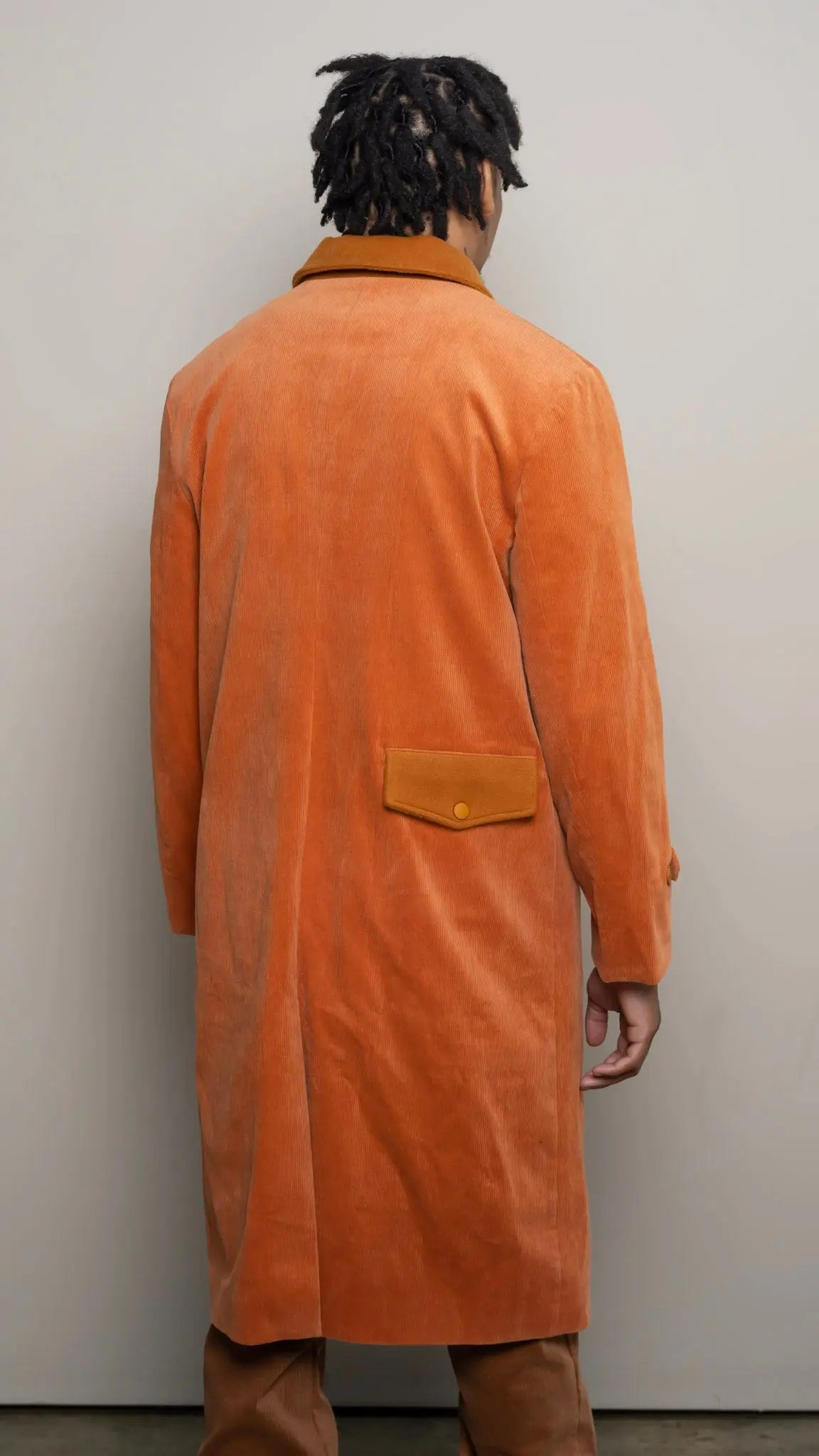 Photo of model in the Arius Juan Burnt Orange Earthly Trench Coat posing for product picture.