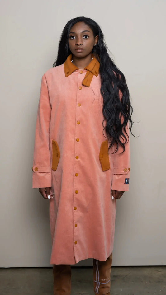 Photo of model in the Arius Juan Salmon Pink Earthly Trench Coat posing for product picture.