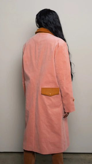 Photo of model in the Arius Juan Salmon Pink Earthly Trench Coat posing for product picture.